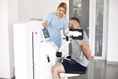 File:Patient-doing-exercise-using-quipment-with-therapist.jpg