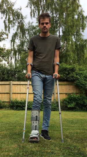 2448px-Teenage boy on crutches with walking boot.jpg