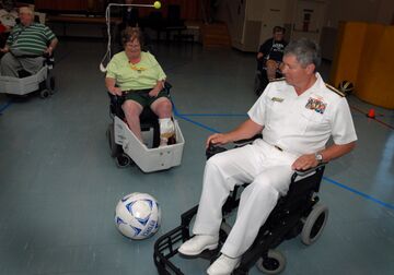 US Navy 100607-N-5208T-001 Rear Adm. Gerald R. Beaman plays a power chair soccer match with rehabilitating veterans at the Milwaukee VA Medical Center.jpg